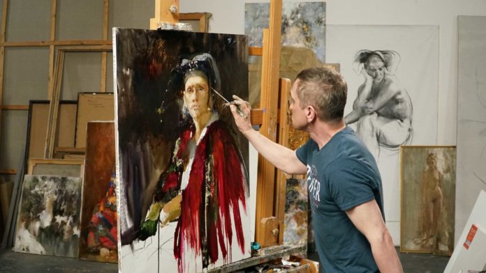 Russian artist Nikolai Blokhin working on a portrait painting