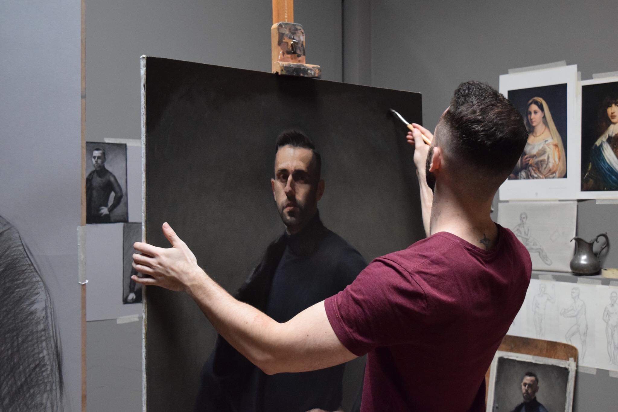 Eric Drummond at the easel, painting a realism portait