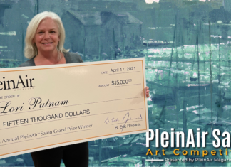 Lori Putnam, holding her $15,000 check from winning the annual Plein Air Salon art competition.