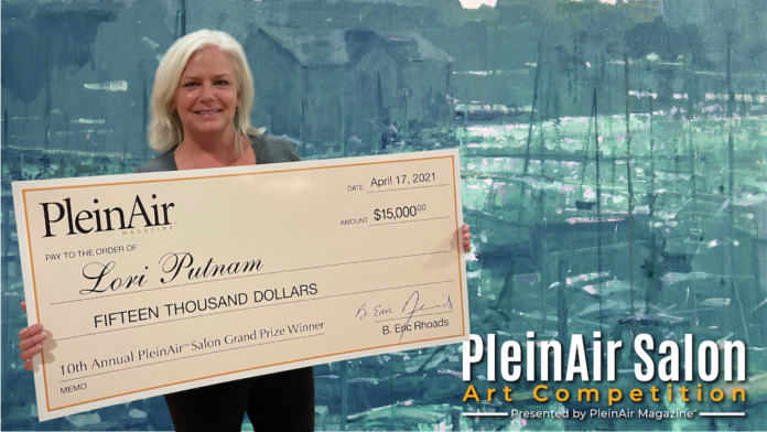 Lori Putnam, holding her $15,000 check from winning the annual Plein Air Salon art competition.
