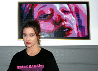 image of artist Pauline in front of her work