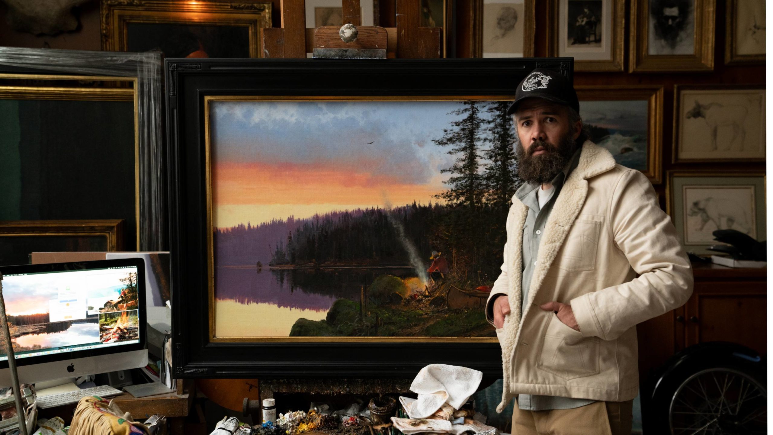 Nicholas Coleman with his oil painting, "By the Fire"