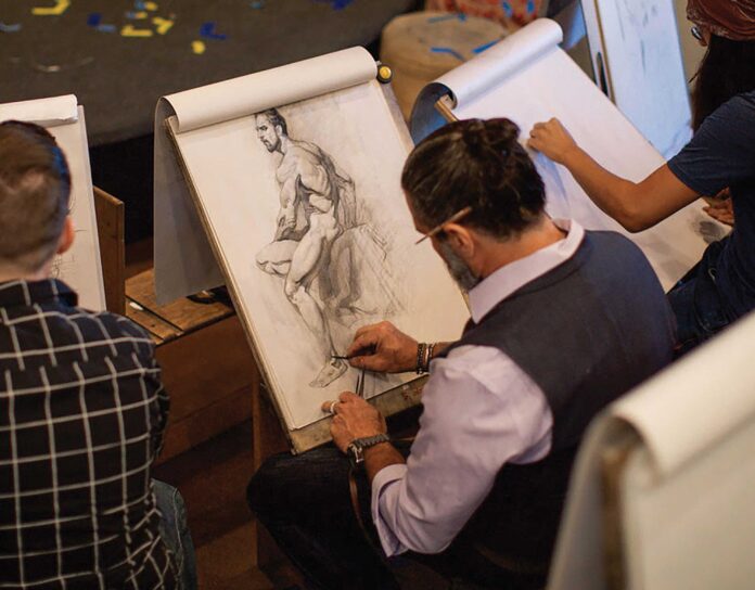 As he works on a figure drawing demonstration piece, Jeffrey Watts wields the long, needle-sharp pencil leads that are characteristic of classical training.