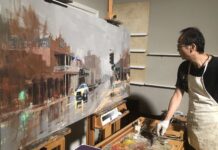 Qiang Huang working on a large-scale painting in his studio