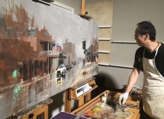 Qiang Huang working on a large-scale painting in his studio