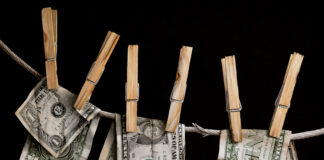 Lynn Pratt, "Money Laundering," watercolor, 21 x 15 in.; painting of money hanging from clothespins